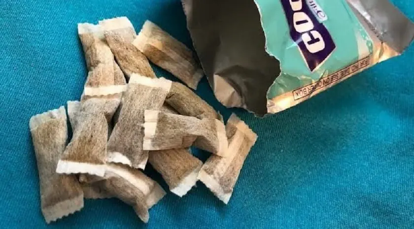 Opened Cool Lip packet with the small tobacco pouches spilled out
